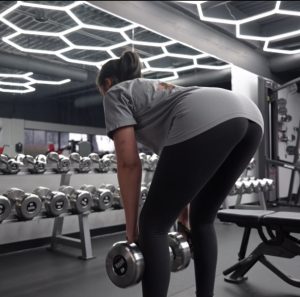 Female client at Fitness Factory KC 24hr gym overland park, ks performing Dumbbell RDL's