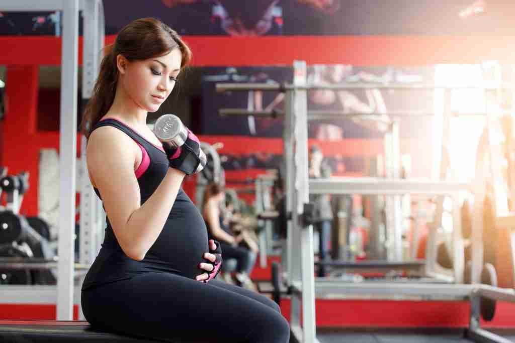 pregnant woman exercising at the gym