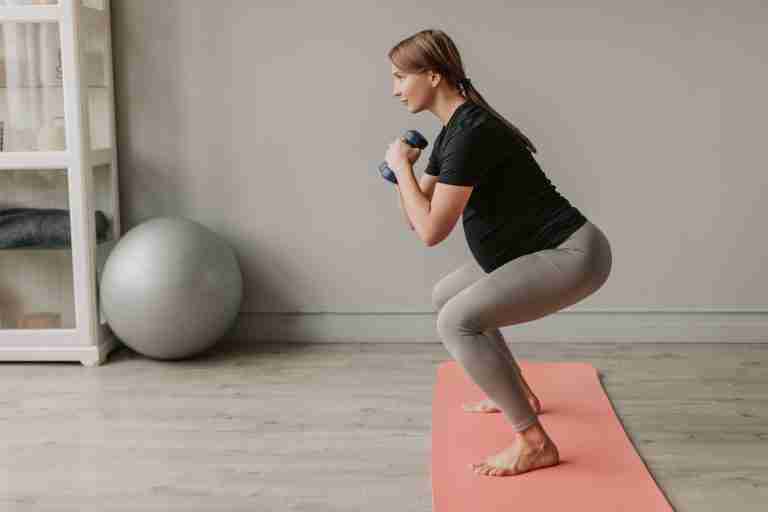 pregnant woman performing squat exercise