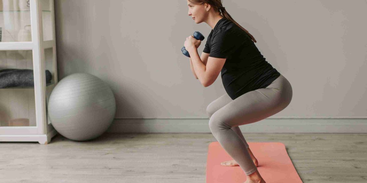pregnant woman performing squat exercise
